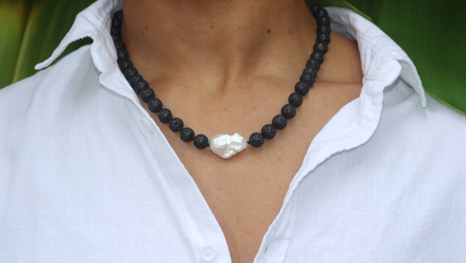 A woman wearing a Pearl necklace