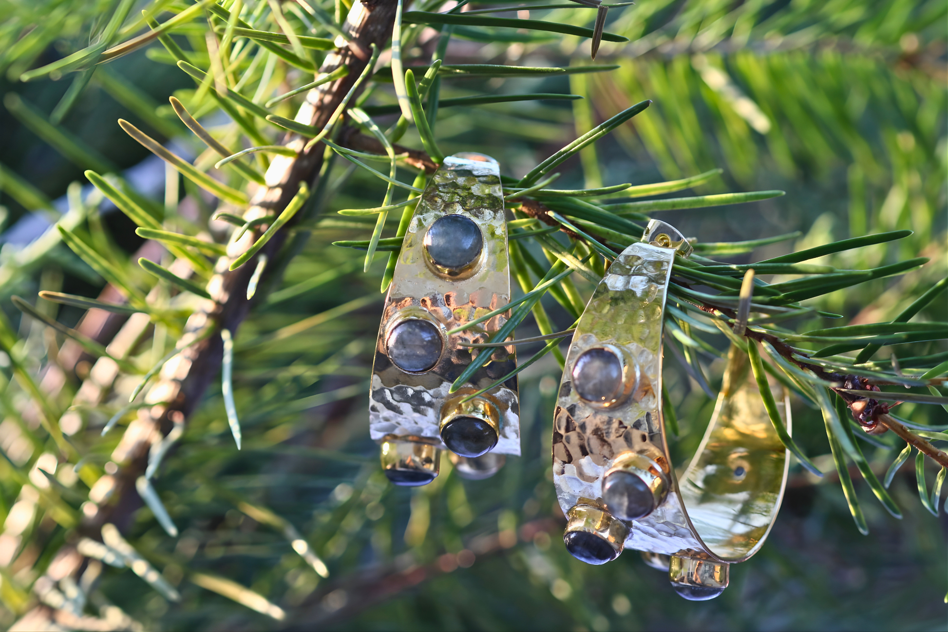 Decorative glass ornaments hanging on a Christmas tree branch